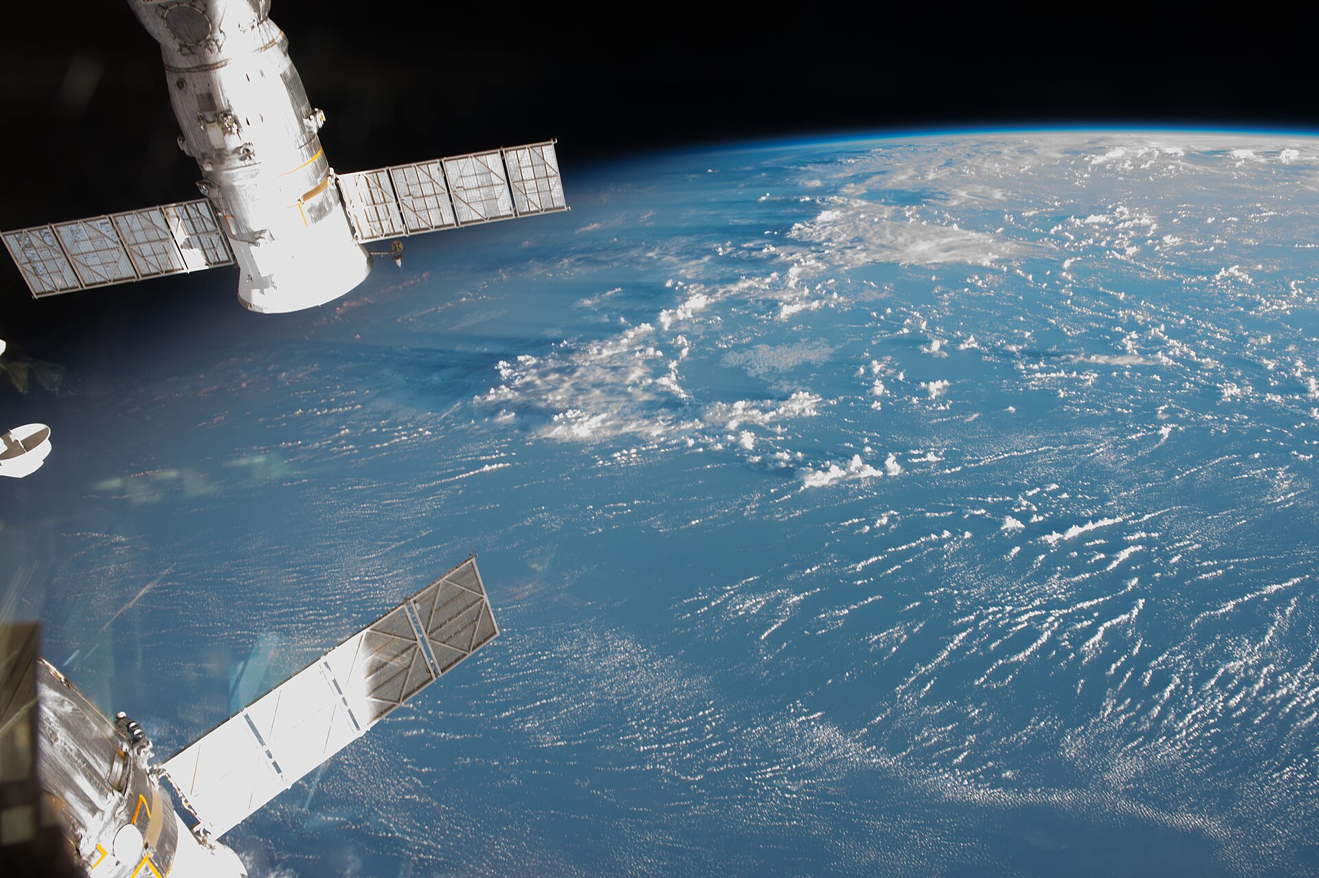 Earth and a docked Soyuz, photographed from the International Space Station
